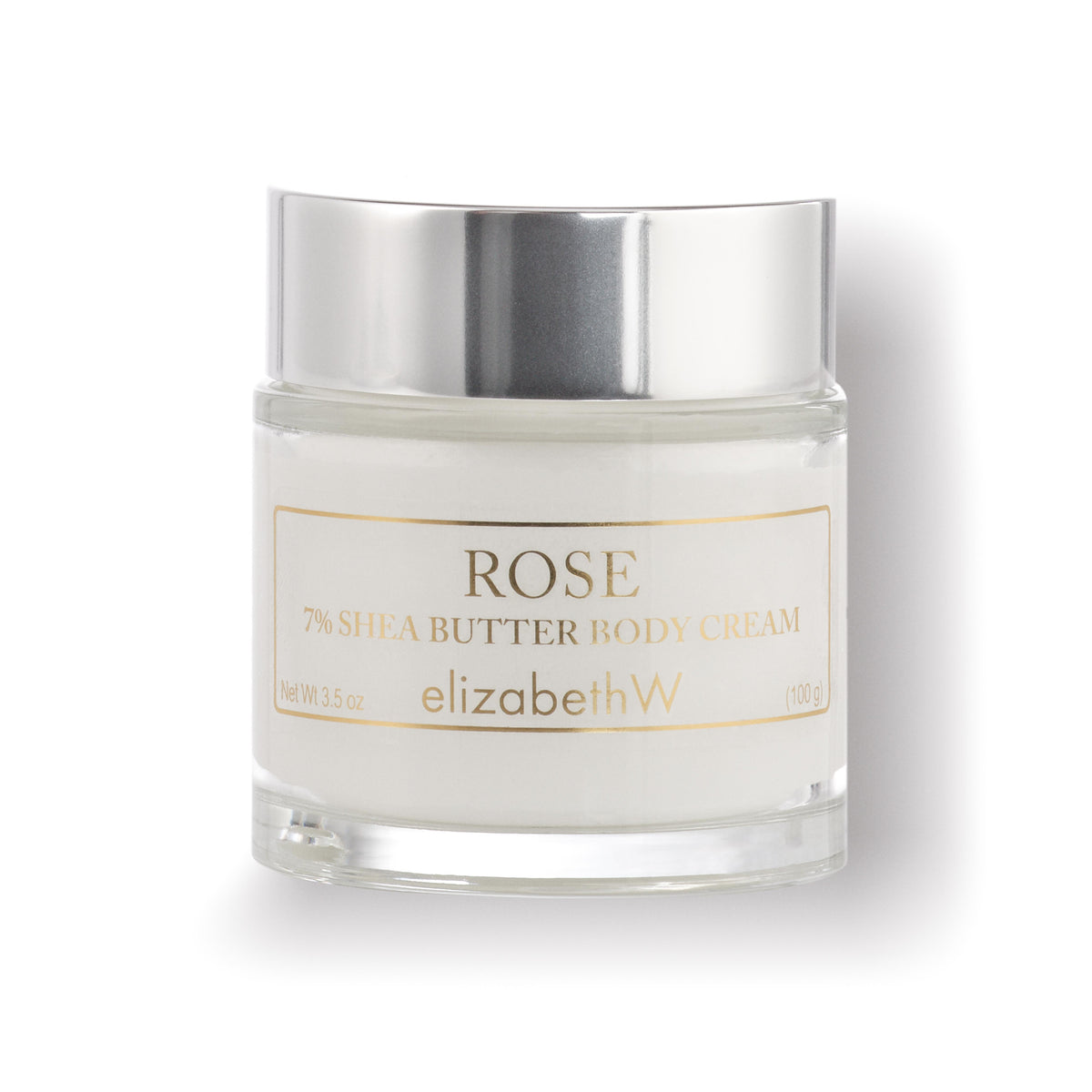 A 3.5 oz (100 g) clear glass jar filled with body cream. The jar has a silver lid, and the label reads &quot;Rose 7% Shea Butter Body Cream&quot; with the elizabethW brand name printed below. 